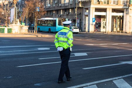 Police agent, Romanian Traffic Police (Politia Rutiera) directing traffic during the morning rush hour in downtown Bucharest, Romania, 2020のeditorial素材