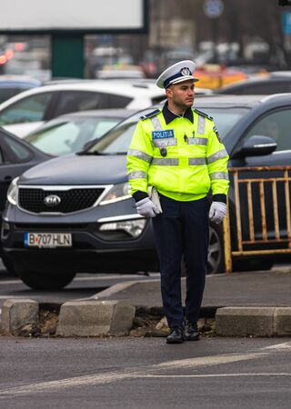 Police agent, Romanian Traffic Police (Politia Rutiera) directing traffic during the morning rush hour in downtown Bucharest, Romania, 2020のeditorial素材