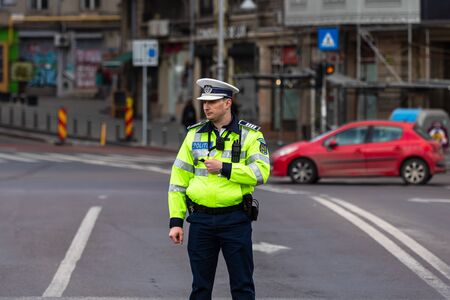 Police agent, Romanian Traffic Police (Politia Rutiera) directing traffic during the morning rush hour in downtown Bucharest, Romania, 2020のeditorial素材