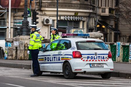 Police agent, Romanian Traffic Police (Politia Rutiera) directing traffic during the morning rush hour in downtown Bucharest, Romania, 2020のeditorial素材
