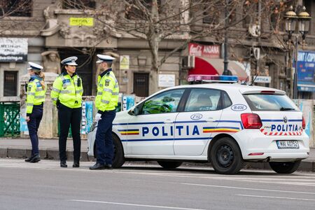 Police agent, Romanian Traffic Police (Politia Rutiera) directing traffic during the morning rush hour in downtown Bucharest, Romania, 2020のeditorial素材