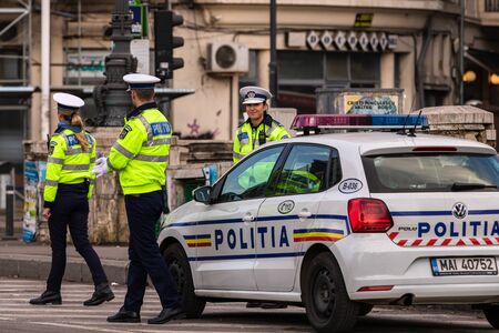 Police agent, Romanian Traffic Police (Politia Rutiera) directing traffic during the morning rush hour in downtown Bucharest, Romania, 2020のeditorial素材