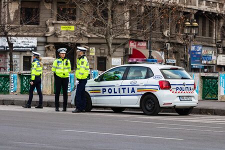 Police agent, Romanian Traffic Police (Politia Rutiera) directing traffic during the morning rush hour in downtown Bucharest, Romania, 2020のeditorial素材