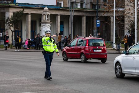 Police agent, Romanian Traffic Police (Politia Rutiera) directing traffic during the morning rush hour in downtown Bucharest, Romania, 2020のeditorial素材