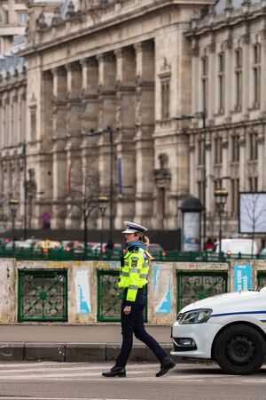 Police agent, Romanian Traffic Police (Politia Rutiera) directing traffic during the morning rush hour in downtown Bucharest, Romania, 2020のeditorial素材