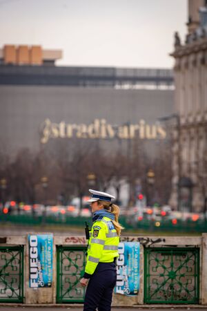 Police agent, Romanian Traffic Police (Politia Rutiera) directing traffic during the morning rush hour in downtown Bucharest, Romania, 2020のeditorial素材