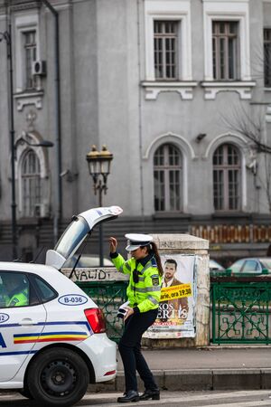 Police agent, Romanian Traffic Police (Politia Rutiera) directing traffic during the morning rush hour in downtown Bucharest, Romania, 2020のeditorial素材