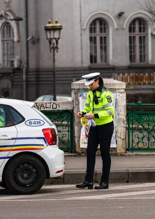 Police agent, Romanian Traffic Police (Politia Rutiera) directing traffic during the morning rush hour in downtown Bucharest, Romania, 2020のeditorial素材