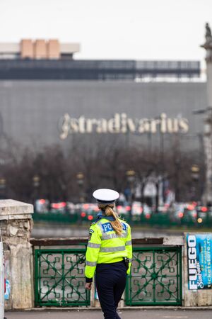 Police agent, Romanian Traffic Police (Politia Rutiera) directing traffic during the morning rush hour in downtown Bucharest, Romania, 2020のeditorial素材