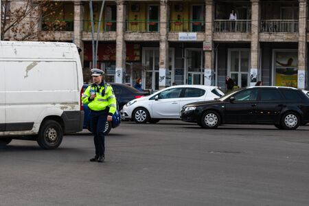 Police agent, Romanian Traffic Police (Politia Rutiera) directing traffic during the morning rush hour in downtown Bucharest, Romania, 2020のeditorial素材