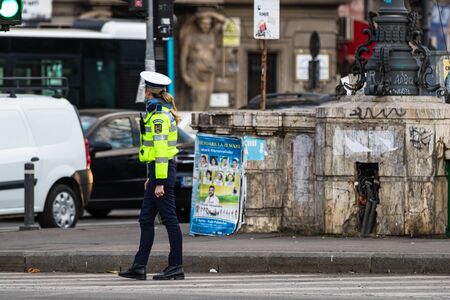 Police agent, Romanian Traffic Police (Politia Rutiera) directing traffic during the morning rush hour in downtown Bucharest, Romania, 2020のeditorial素材