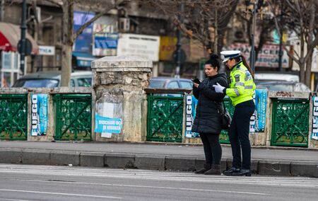 Police agent, Romanian Traffic Police (Politia Rutiera) directing traffic during the morning rush hour in downtown Bucharest, Romania, 2020のeditorial素材