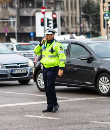 Police agent, Romanian Traffic Police (Politia Rutiera) directing traffic during the morning rush hour in downtown Bucharest, Romania, 2020のeditorial素材