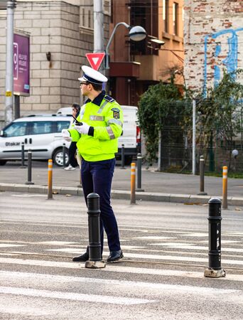 Police agent, Romanian Traffic Police (Politia Rutiera) directing traffic during the morning rush hour in downtown Bucharest, Romania, 2020のeditorial素材