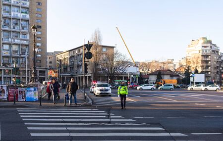 Police agent, Romanian Traffic Police (Politia Rutiera) directing traffic during the morning rush hour in downtown Bucharest, Romania, 2020のeditorial素材