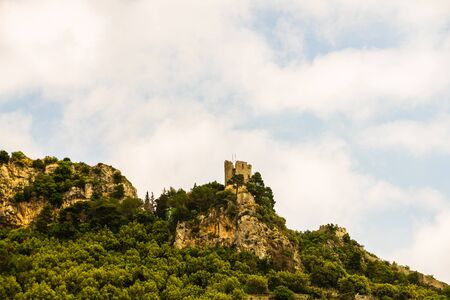 Old medieval castle tower, the Amalfi Coast (Italy), surrounded by trees and rocksのeditorial素材