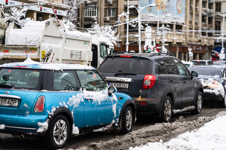 Snow on cars in the morning. Winter season and icy cars on the road in morning rush hour traffic of...