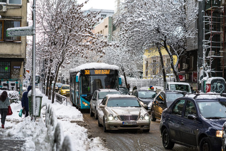 Snow on cars in the morning. Winter season and icy cars on the road in morning rush hour traffic of Bucharest, Romania, 2020のeditorial素材