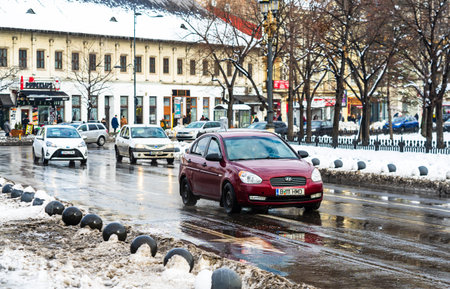 Winter season and icy cars on the road in the morning rush hour traffic in Bucharest, Romania, 2020