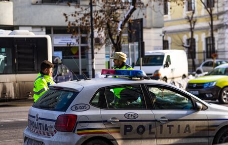 Police agents, Romanian Traffic Police (Politia Rutiera) directing traffic during the morning rush hour in downtown Bucharest, Romania, 2020のeditorial素材