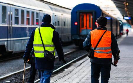 Train crew doing the last checking on the platform at the Bucharest North Railway Station (Gara de Nord Bucuresti) in Bucharest, Romania, 2020のeditorial素材