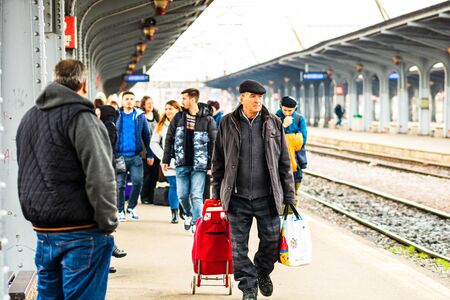 Travelers and commuters waiting for a train on the platform of Bucharest North Railway Station (Gara de Nord) in Bucharest, Romania, 2020のeditorial素材