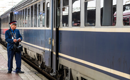 Train crew doing the last checking on the platform at the Bucharest North Railway Station (Gara de Nord Bucuresti) in Bucharest, Romania, 2020のeditorial素材