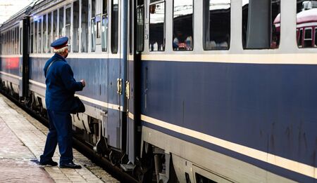Train crew doing the last checking on the platform at the Bucharest North Railway Station (Gara de Nord Bucuresti) in Bucharest, Romania, 2020のeditorial素材