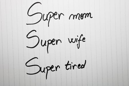 Super mom super wife super tired writing love text for mother on paper. Label tag with lovely message for mother`s day.の写真素材