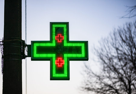 Medical (pharmacy) led plus sign display board close up.の写真素材