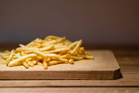 French fries on a wooden table. Food, junk food and fast food conceptの写真素材