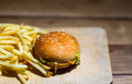 French fries and chicken burger on a wooden table. Food, junk food and fast food conceptの写真素材