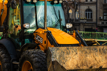 Excavator in traffic at rush hour, car pollution, traffic jam in the morning and evening in the...