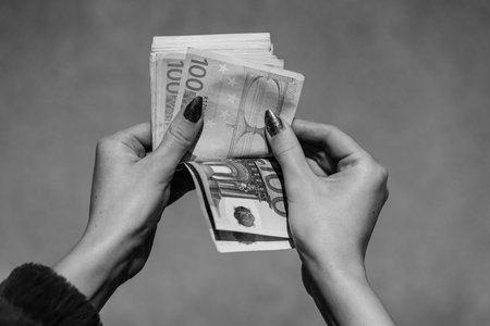 Hand couting holding and showing euro money or giving money. World money concept, 100 EURO banknotes...