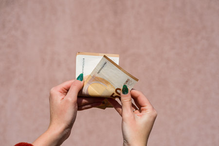 Hand couting holding and showing euro money or giving money. World money concept, 50 EURO banknotes...