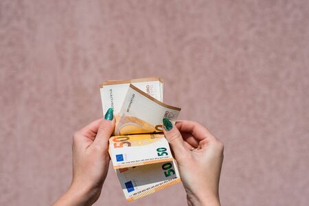 Hand couting holding and showing euro money or giving money. World money concept, 50 EURO banknotes EUR currency isolated with copy space. Concept of rich business people, saving or spending money.の写真素材