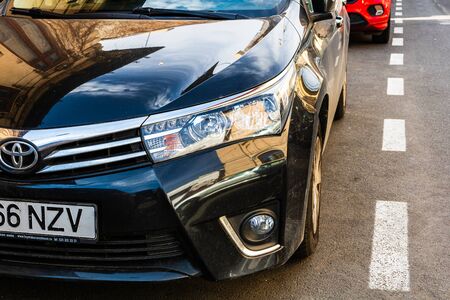 Detail and front view of Toyota car in a parking lot. Bucharest, Romania, 2020.のeditorial素材