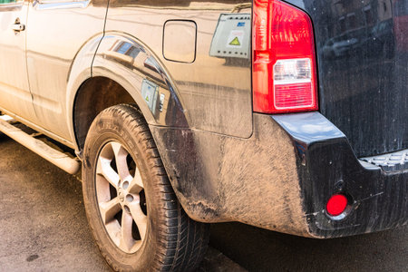Detail view of dirty Nissan car, dirty wheels. Bucharest, Romania, 2020.