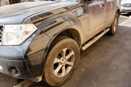 Detail view of dirty Nissan car, dirty wheels. Bucharest, Romania, 2020.のeditorial素材