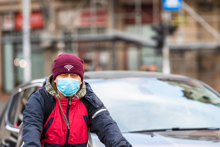 Covid-19 flu disease virus spreading in Europe. People wearing medical mask against coronavirus,...