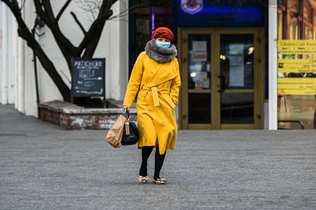 Covid-19 flu disease virus spreading in Europe. People wearing medical mask against coronavirus, influenza viruses and diseases. Healthcare concept. Woman wearing surgical mask on face in public spaces in Bucharest, Romania, 2020のeditorial素材