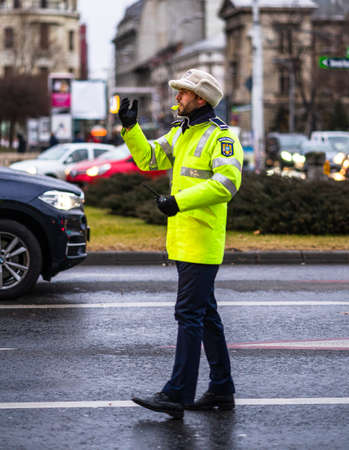 Police agent, Romanian Traffic Police (Politia Rutiera) directing traffic during the morning or evening rush hour in downtown Bucharest, Romania, 2020のeditorial素材