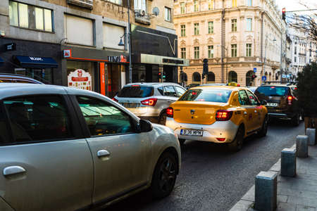 Car traffic at rush hour in downtown area of the city. Car pollution, traffic jam in the morning and evening in the capital city of Bucharest, Romania, 2020のeditorial素材