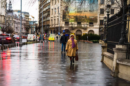 Woman walking on a rainy day on the main boulevard of Bucharest city, Romania 2020のeditorial素材