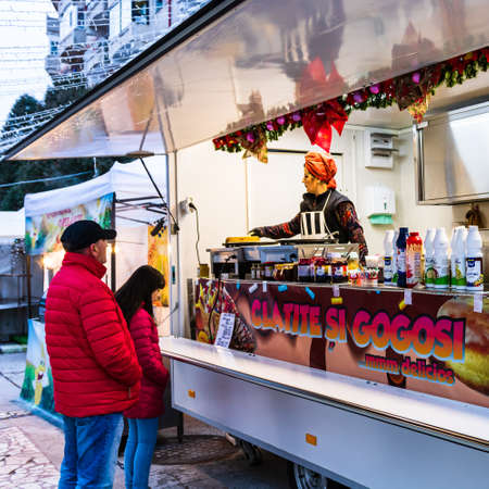 People waiting for buying pancakes or donuts at a food festival in Targoviste, Romania, 2020.のeditorial素材