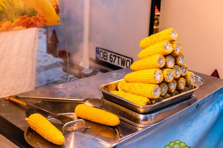 Grilled, roasted sweet corn ready to sell at a street food festivalの写真素材