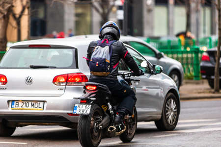 Honda motorcycle in traffic in downtown of Bucharest, Romania, 2020.のeditorial素材