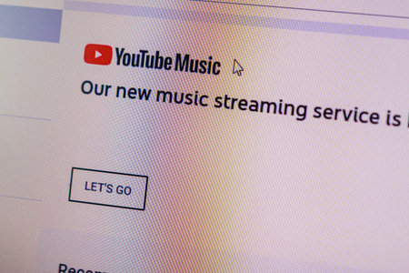 Youtube Music home menu and arrow cursor on device screen pixelated close up view. Bucharest,...