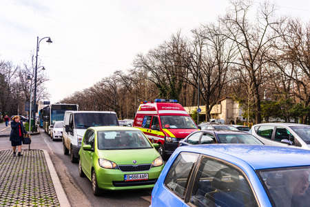 Ambulance stuck in traffic in downtown area of Bucharest. Car pollution, traffic jam in the morning and evening in the capital city of Bucharest, Romania, 2020のeditorial素材