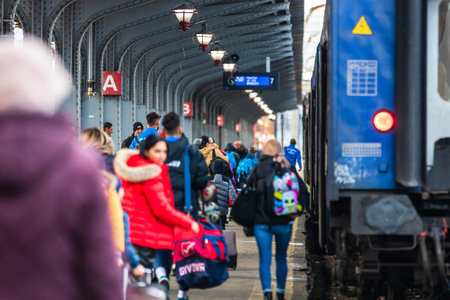 Travelers and commuters waiting for a train on the train platform of Bucharest North Railway Station...